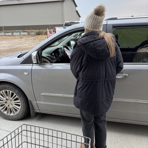 image of someone filling out paperwork in their car